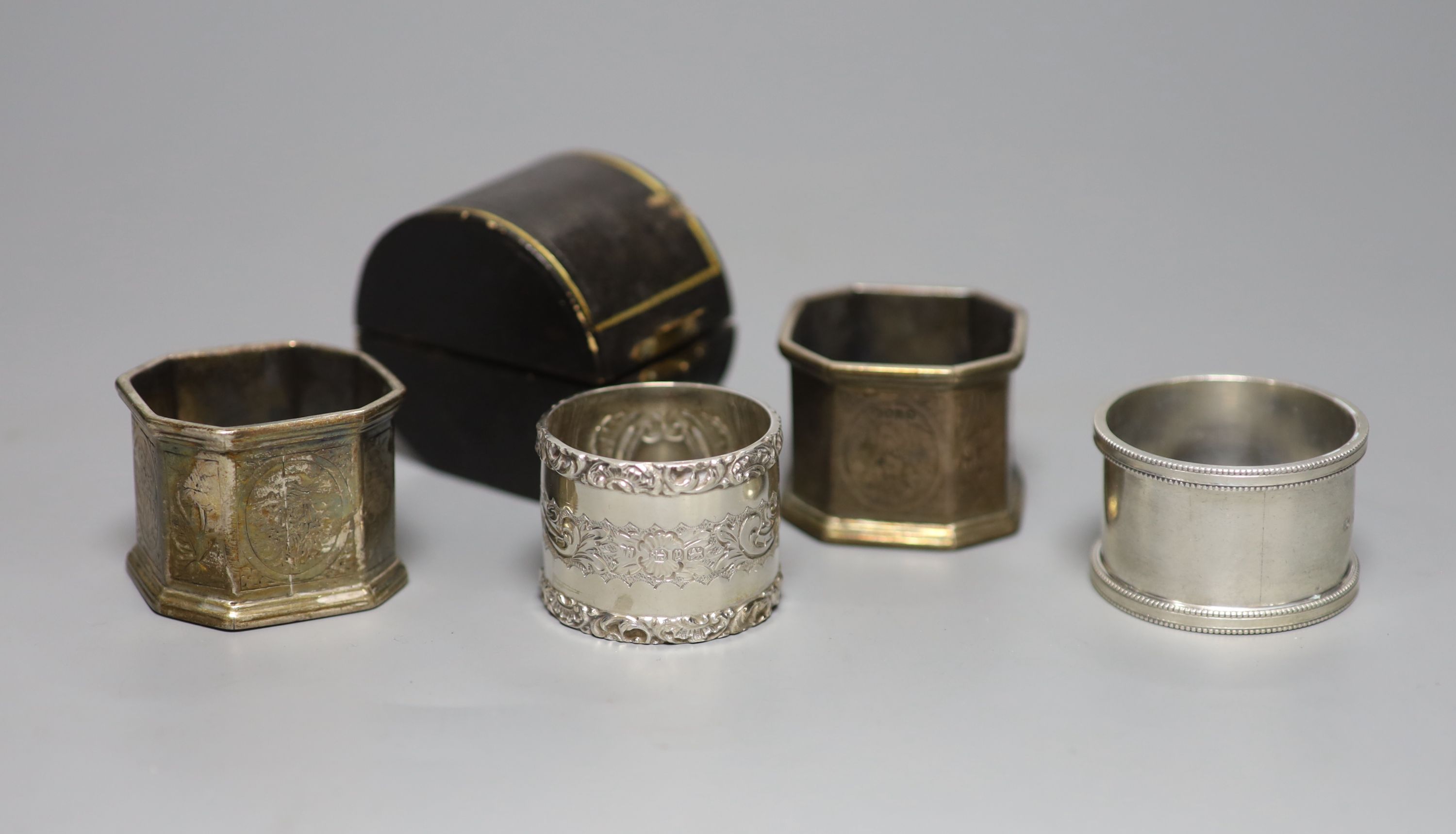 A cased late Victorian silver napkin ring, one other similar pair and a later silver napkin ring
